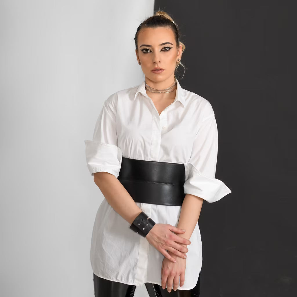 Aria Margo wide black Italian leather corset belt worn over a white button-down shirt for a defined waist.