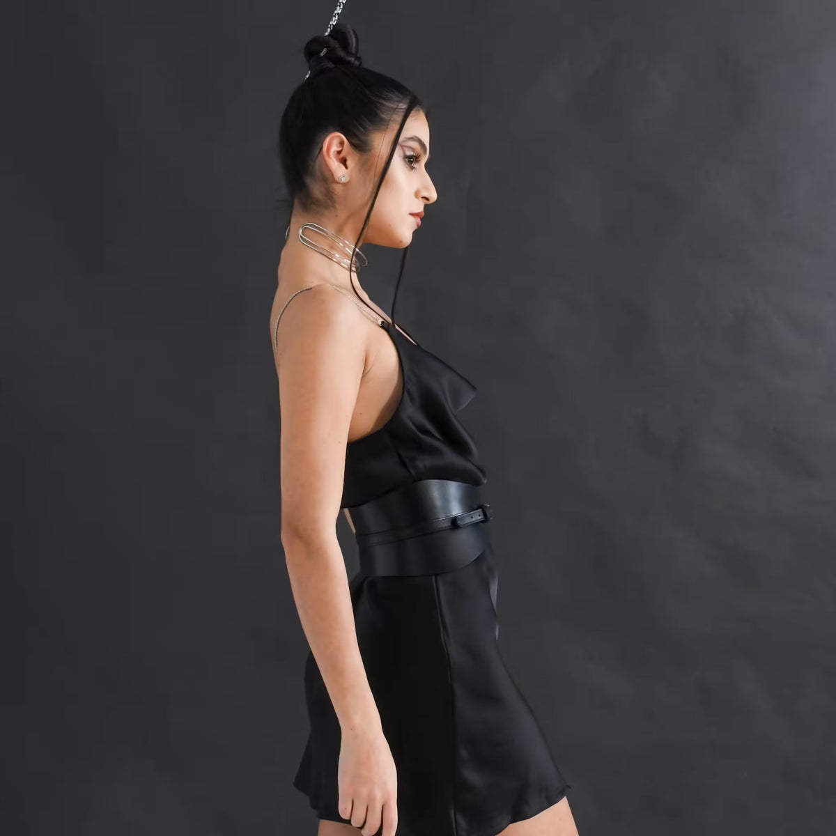 Aria Margo slim black Italian leather corset belt worn by a model over a black silk dress