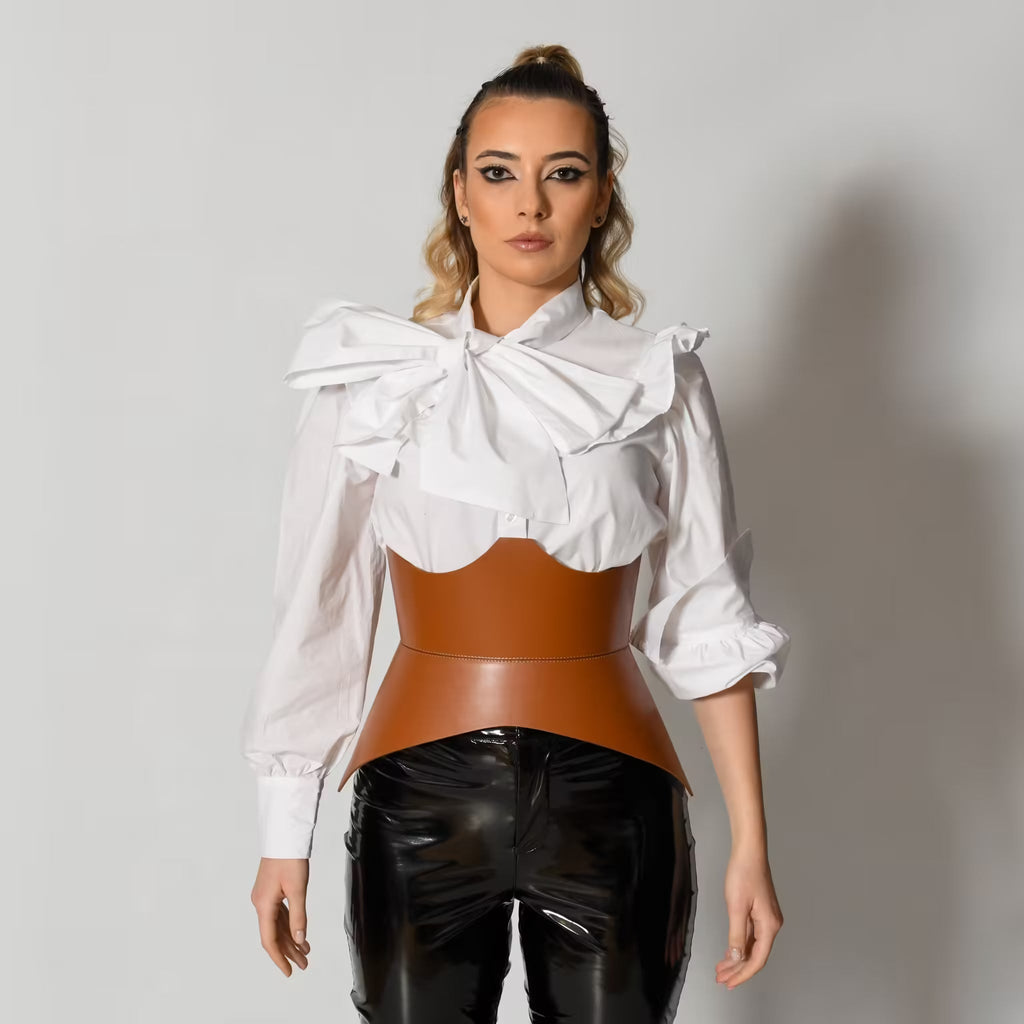 Aria Margo brown Italian leather corset belt worn over a white ruffled blouse and black trousers