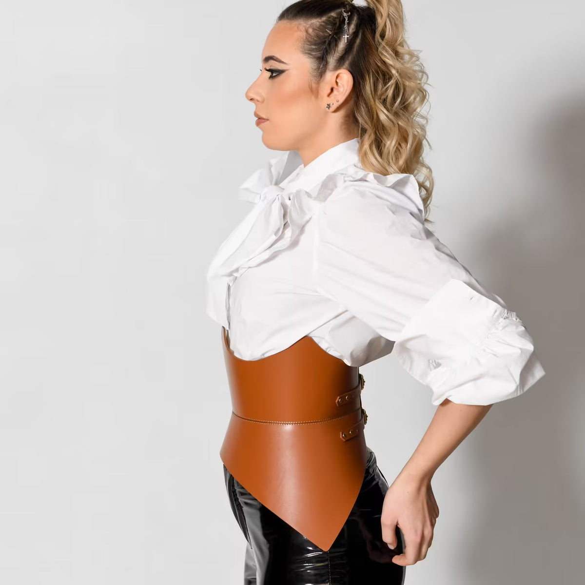 Aria Margo brown Italian leather corset belt worn over a white blouse to create an hourglass silhouette
