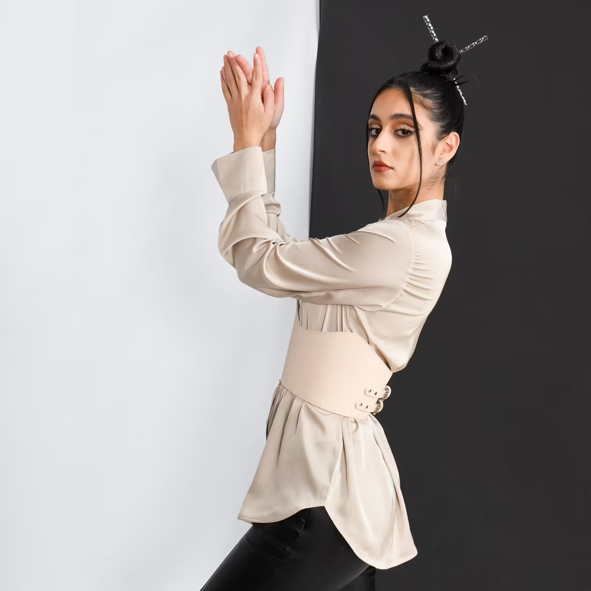 Aria Margo beige leather under-bust belt worn by a model over a silk blouse for a structured waistline.