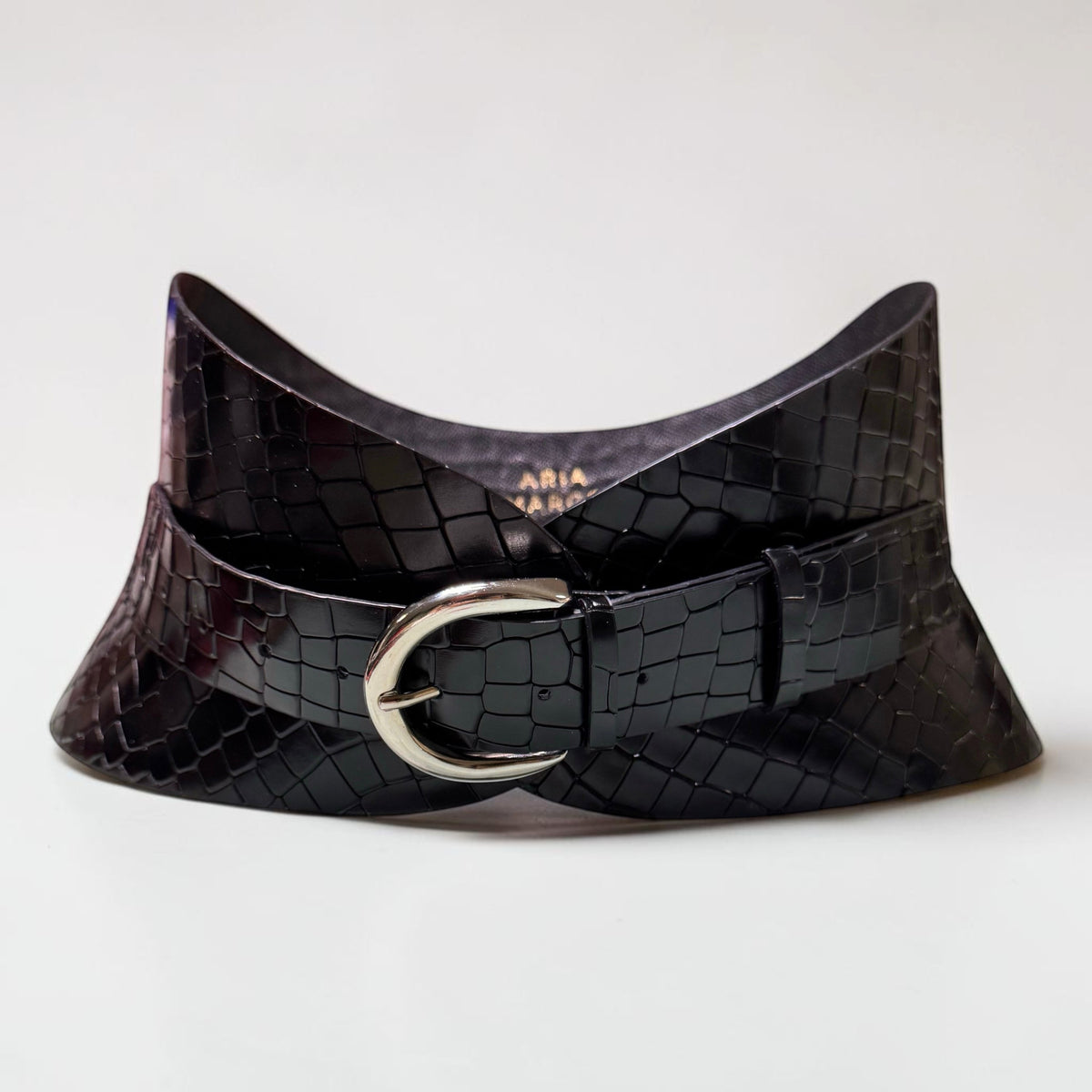 Aria Margo black croc-embossed leather hourglass corset belt with a slim silver buckle on a white surface.