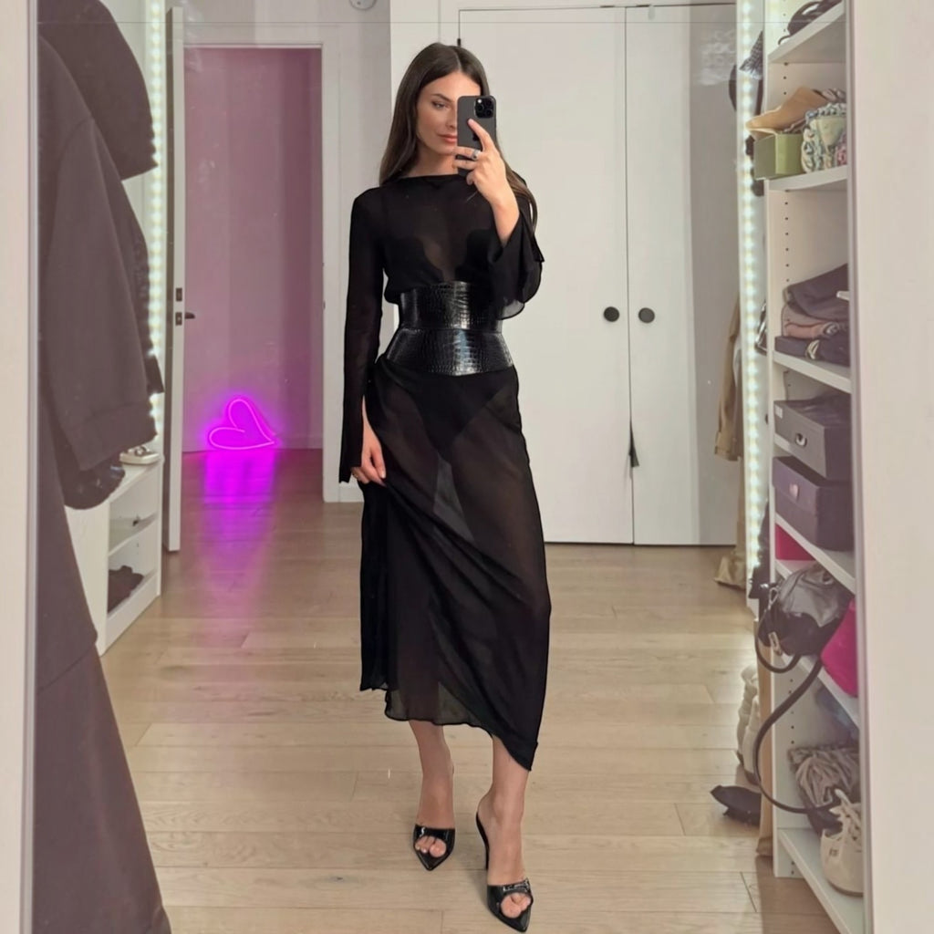 Aria Margo black croc-embossed leather corset belt worn over a sheer black dress for a stylish hourglass look.