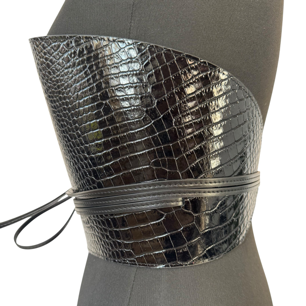 Aria Margo black croc-embossed leather waist belt with a wrap-around cord design on a mannequin torso.
