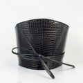 Aria Margo black croc-embossed leather waist belt with a wrap-around cord tie and structured silhouette.