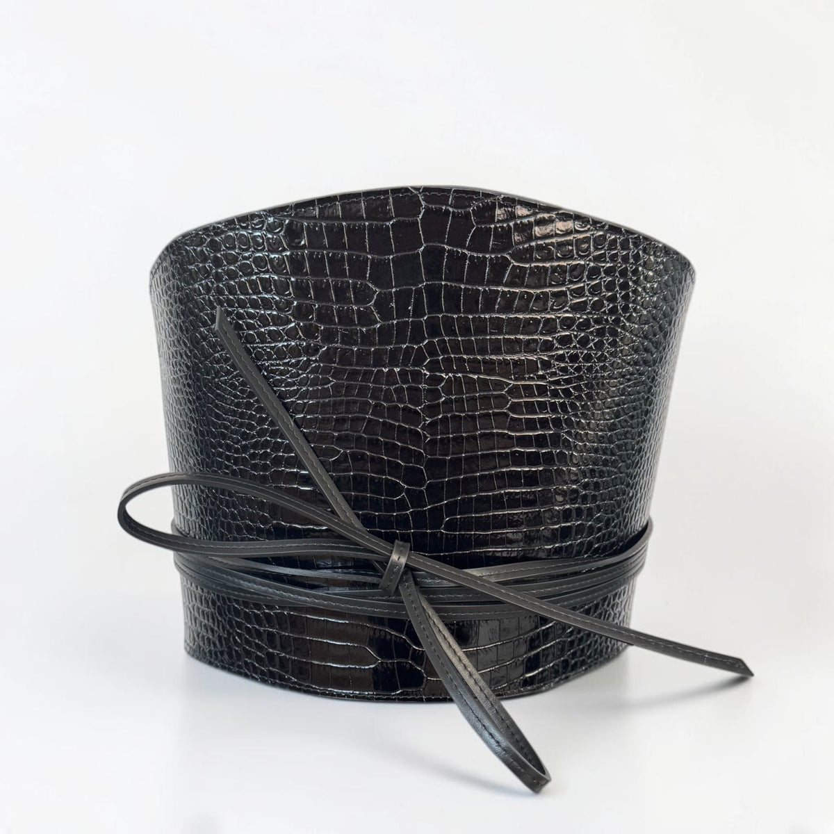Aria Margo black croc-embossed leather waist belt with a wrap-around cord tie and structured silhouette.