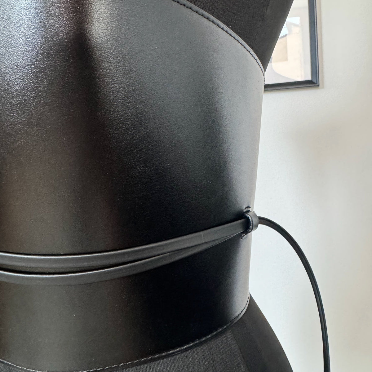 Aria Margo black leather corset belt with wrap-around cord detail on a mannequin torso.