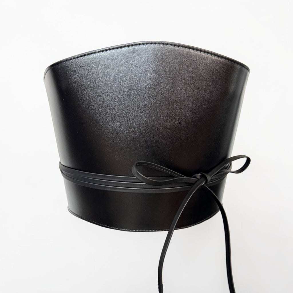 Aria Margo black Italian leather corset belt with wrap-around cord lacing and side loops on a white background.