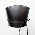 Aria Margo black Italian leather corset belt with wrap-around cord lacing and side loops on a white background.