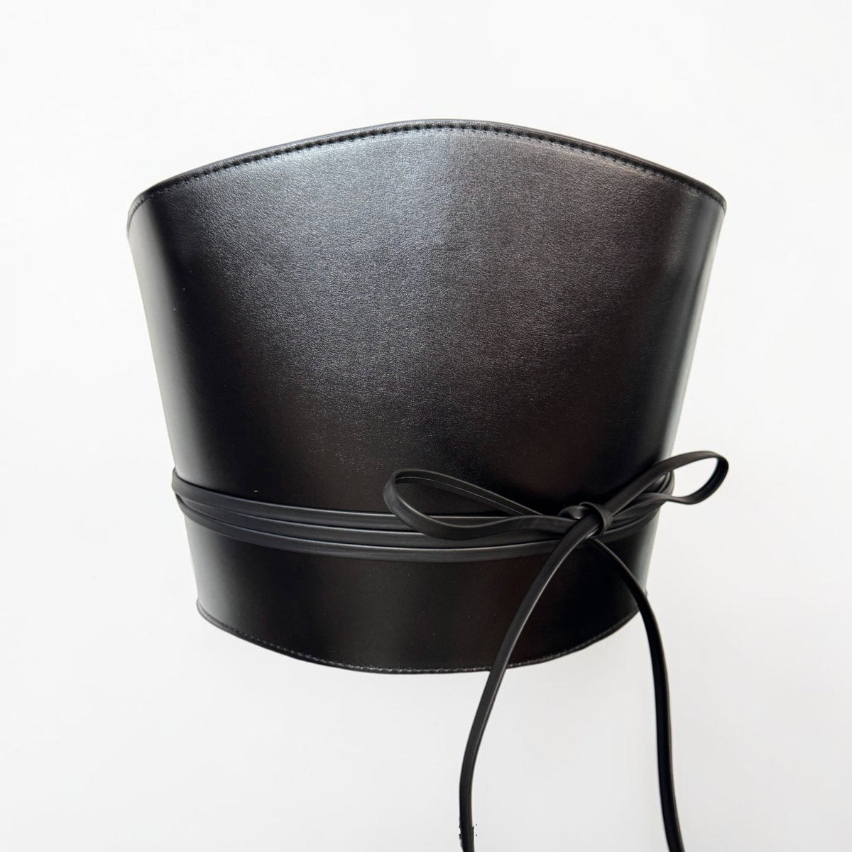 Aria Margo black Italian leather corset belt with wrap-around cord lacing and side loops on a white background.