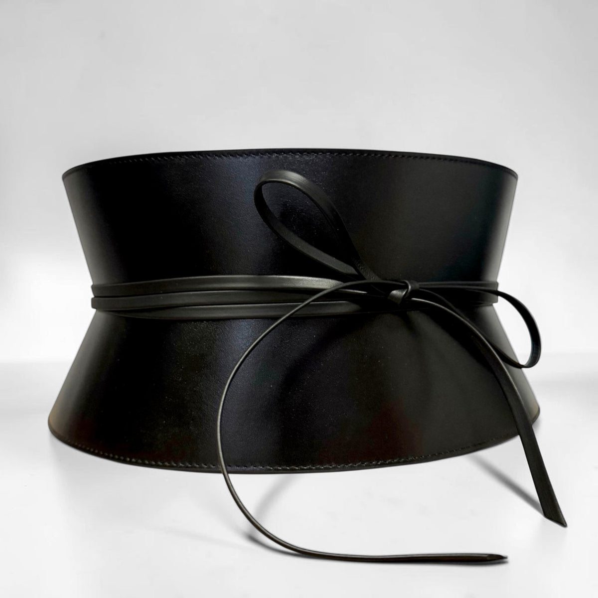 Aria Margo wide black Italian leather corset belt with a structured hourglass shape and delicate cord lacing.