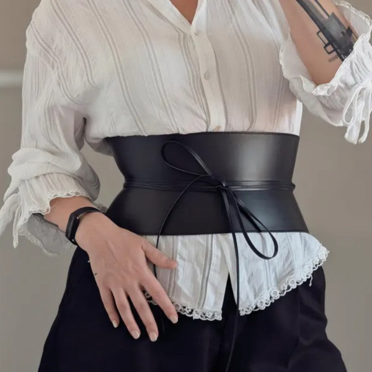 Aria Margo wide black leather corset belt with lace-up front detail worn over a white button-down shirt.