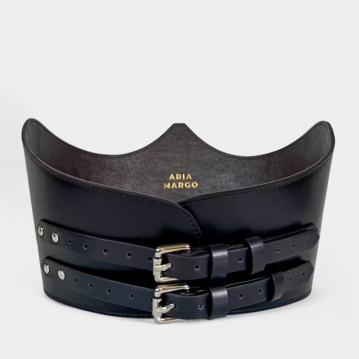 Aria Margo black Italian leather under-bust belt with two adjustable silver buckles and a sculpted crown shape.