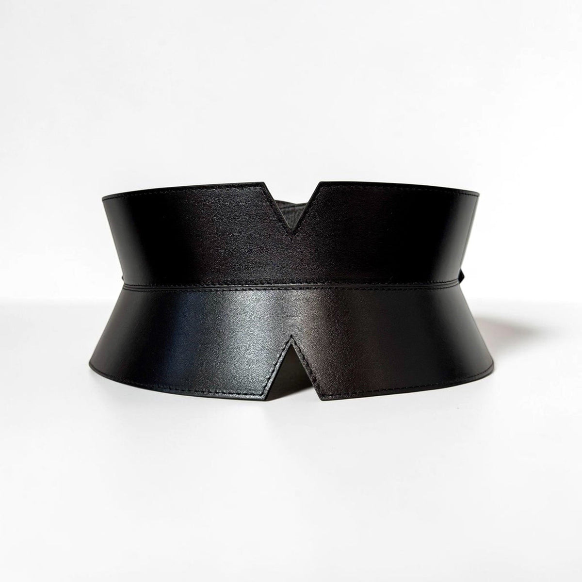 Aria Margo black leather corset belt with a V-cut front, featuring precise stitching and a minimalist design.