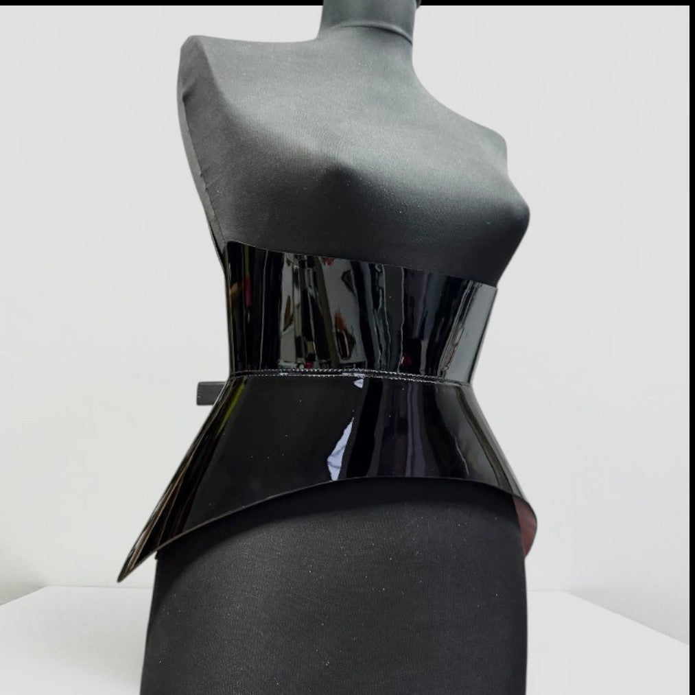Aria Margo Test black patent leather corset belt with a high-shine finish on a mannequin torso.