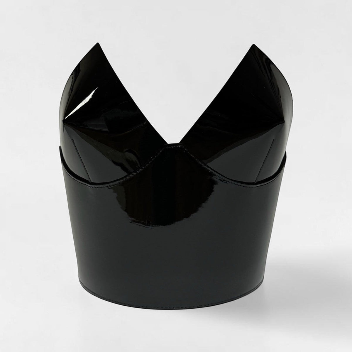 Aria Margo black patent leather over-bust corset with a structured, high-shine finish and sculptural neckline.