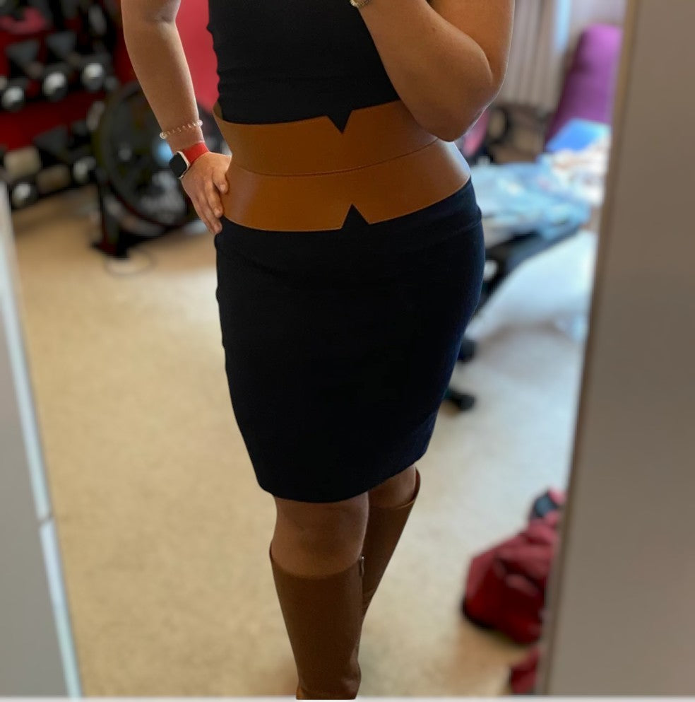 Aria Margo brown leather V-cut corset belt worn over a black dress to create an hourglass silhouette