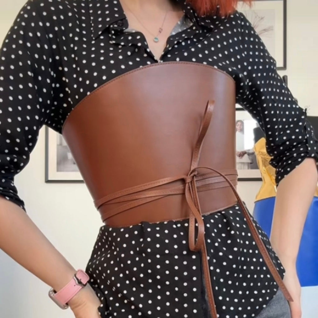 Aria Margo brown Italian leather corset belt with wrap-around cord ties worn over a black polka dot shirt.