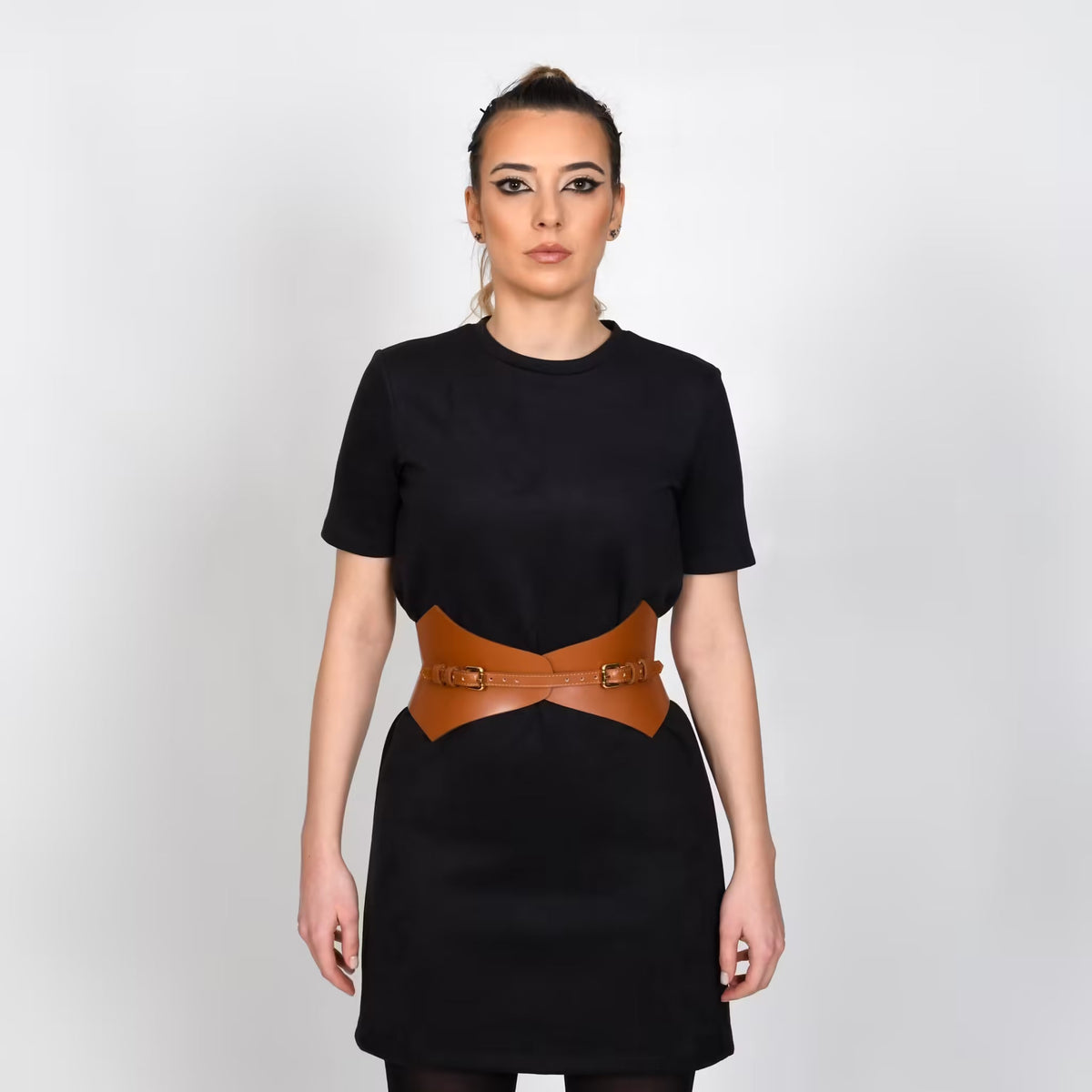 Aria Margo brown Italian leather corset belt with pointed lines worn over a black dress for a defined waistline