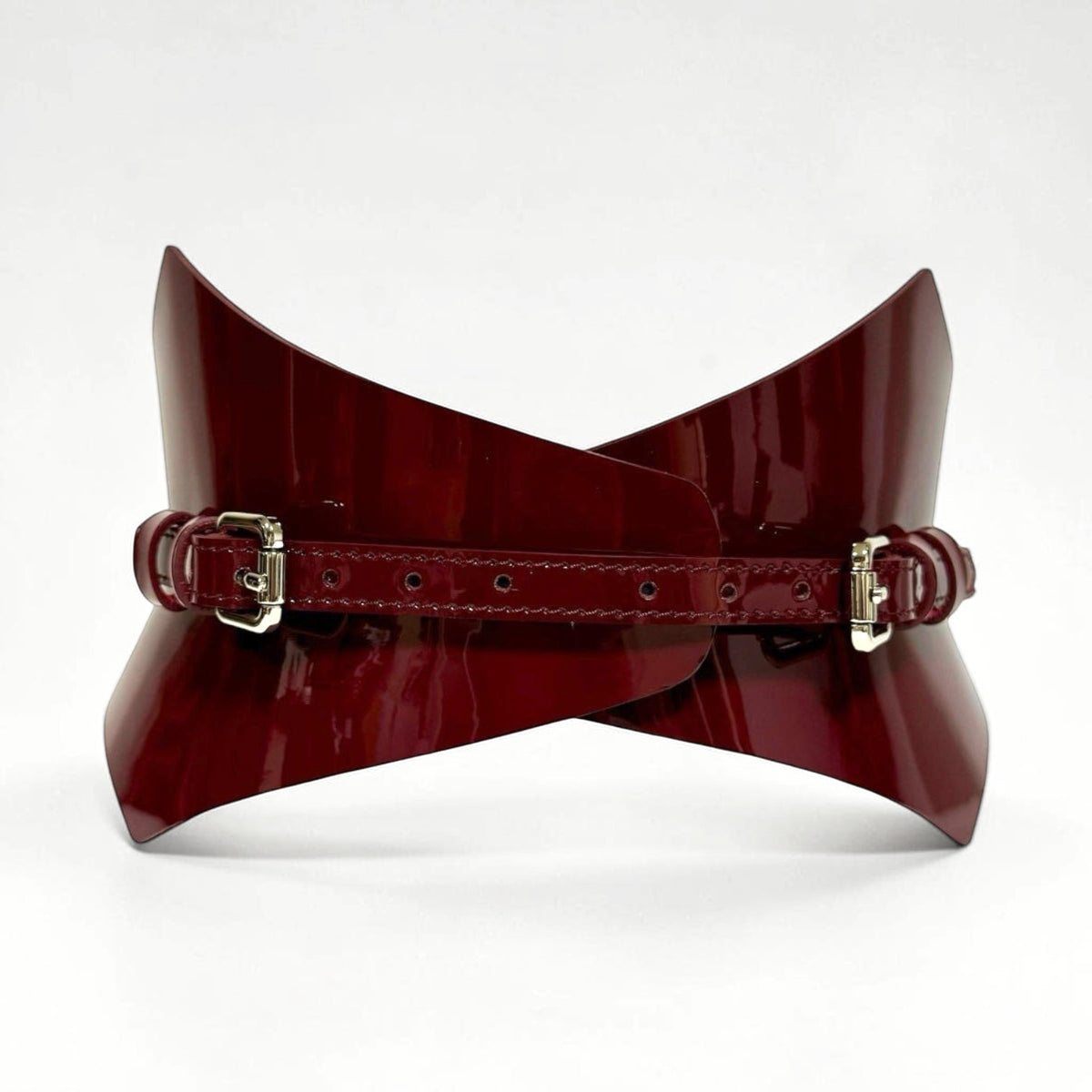 Aria Margo burgundy patent leather corset belt with a pointed silhouette and silver buckle detail.