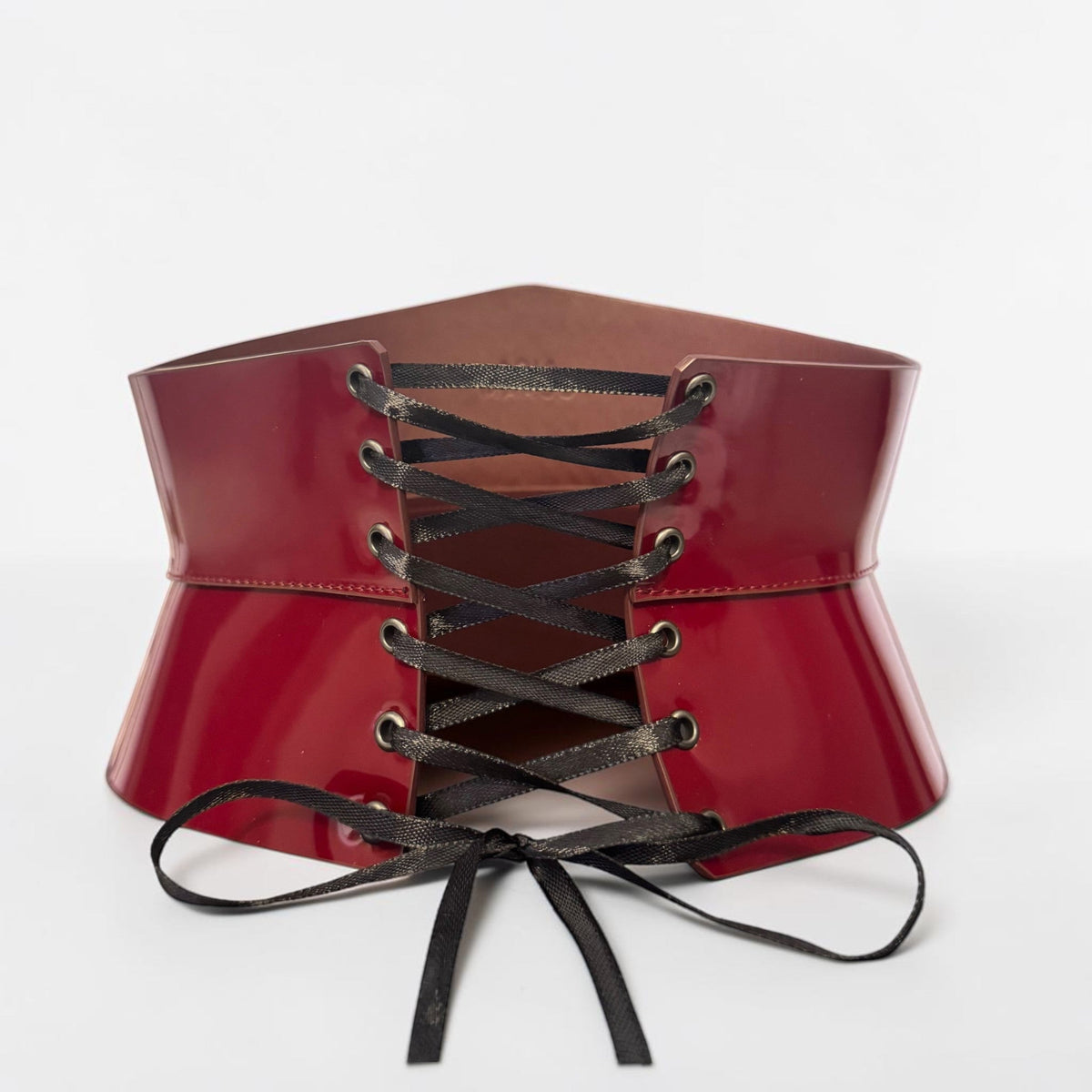 Aria Margo burgundy Italian leather corset belt with black satin lace-up front in an hourglass silhouette.