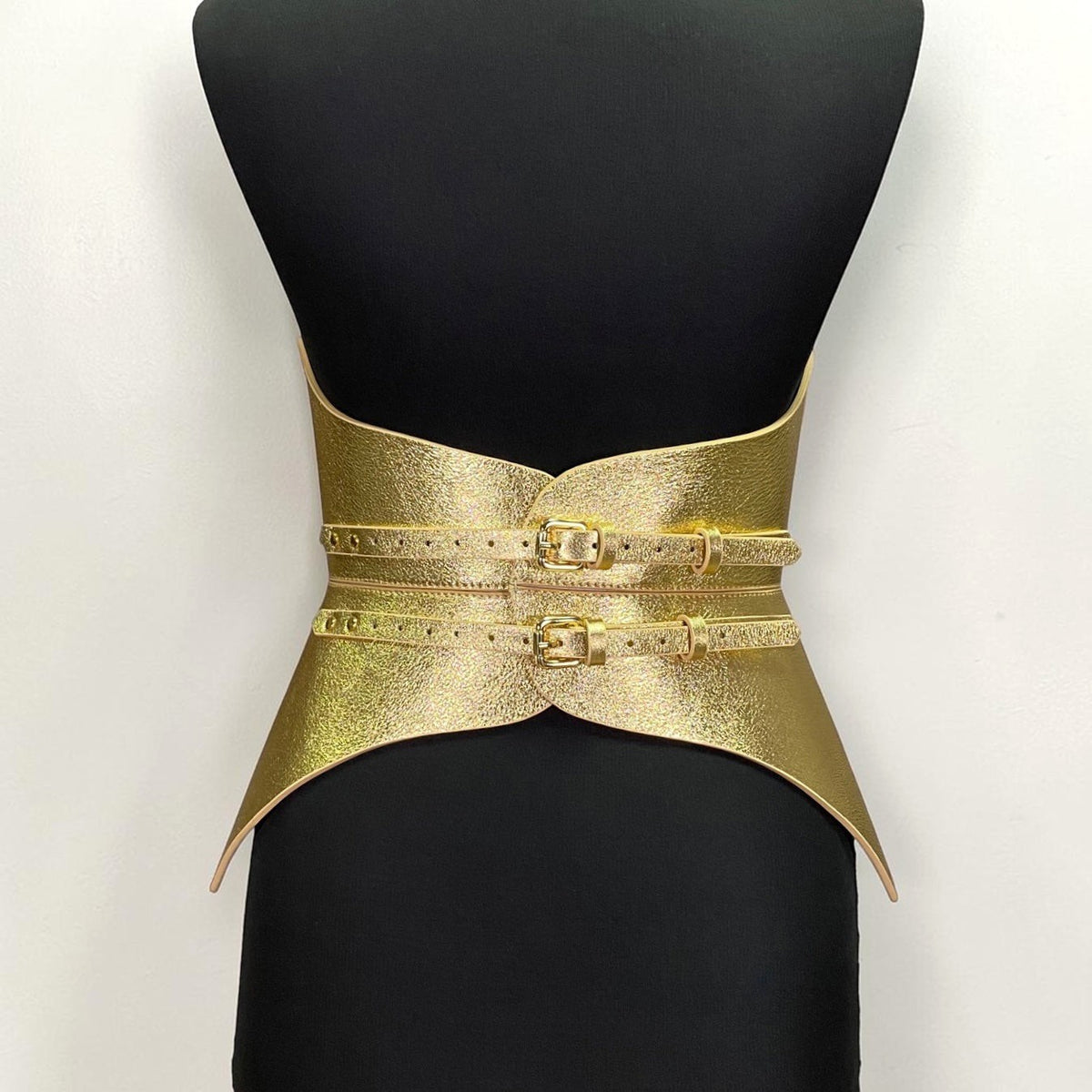 Aria Margo gold leather full body corset belt with two polished buckles and a structured futuristic silhouette.