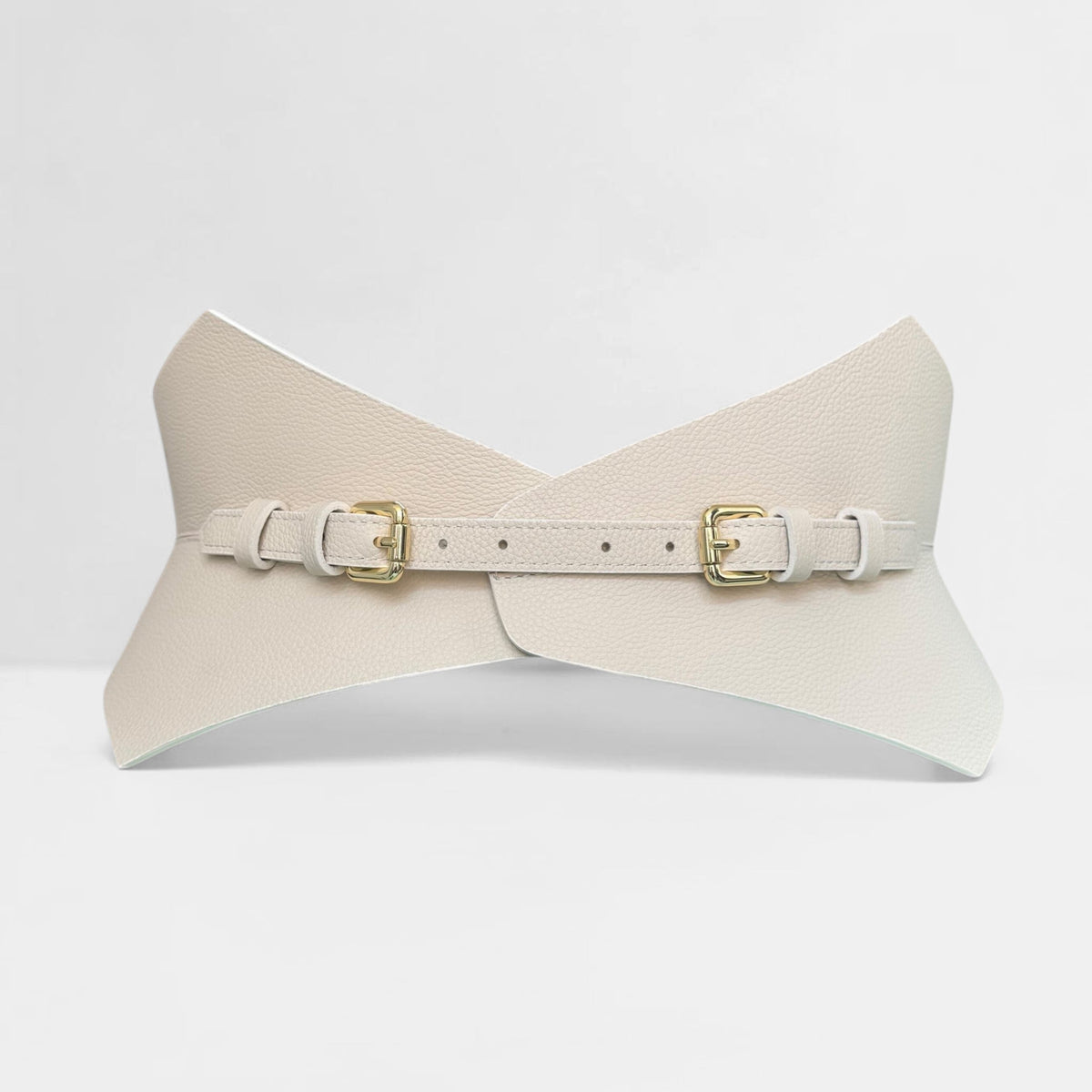 Aria Margo ivory leather corset belt with gold buckles and pointed silhouette on a neutral surface