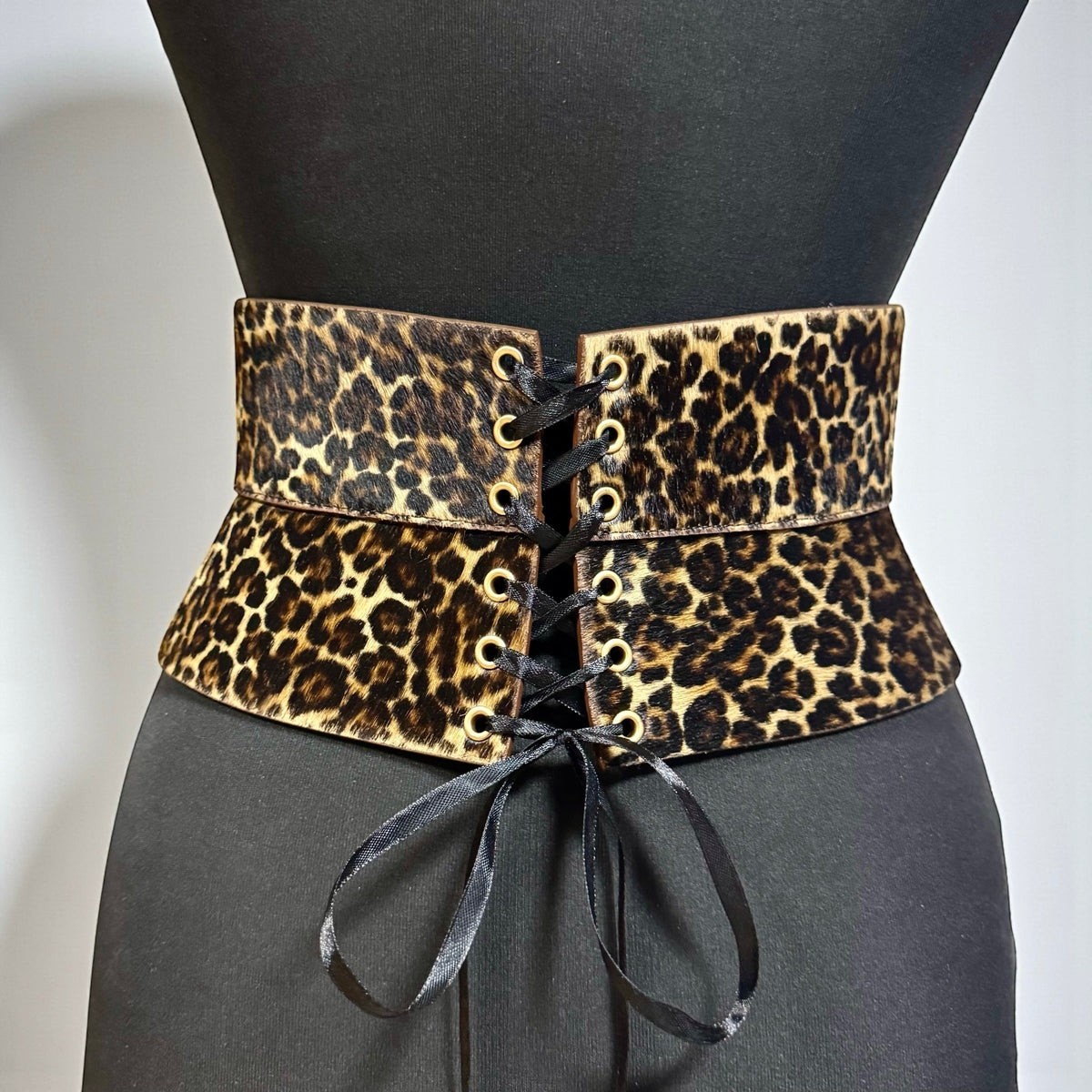 Aria Margo leopard print pony-hair leather corset belt with black satin lace-up front on a mannequin