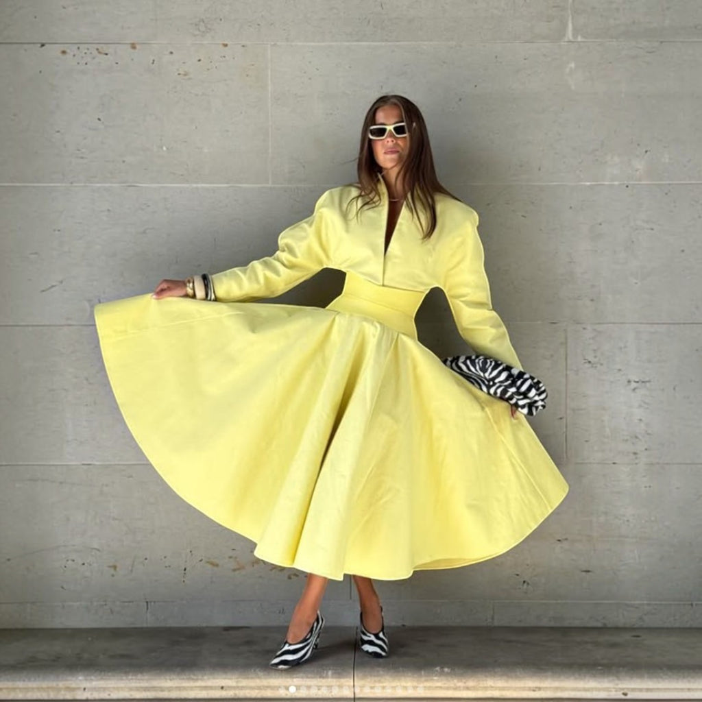 Aria Margo pale yellow leather corset belt worn over a matching yellow dress with zebra print accessories