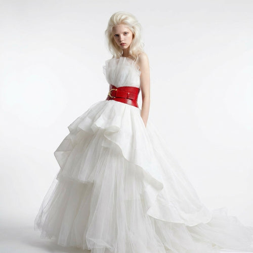 Aria Margo red croc-embossed leather corset belt worn by a model in a white tulle gown against a white background