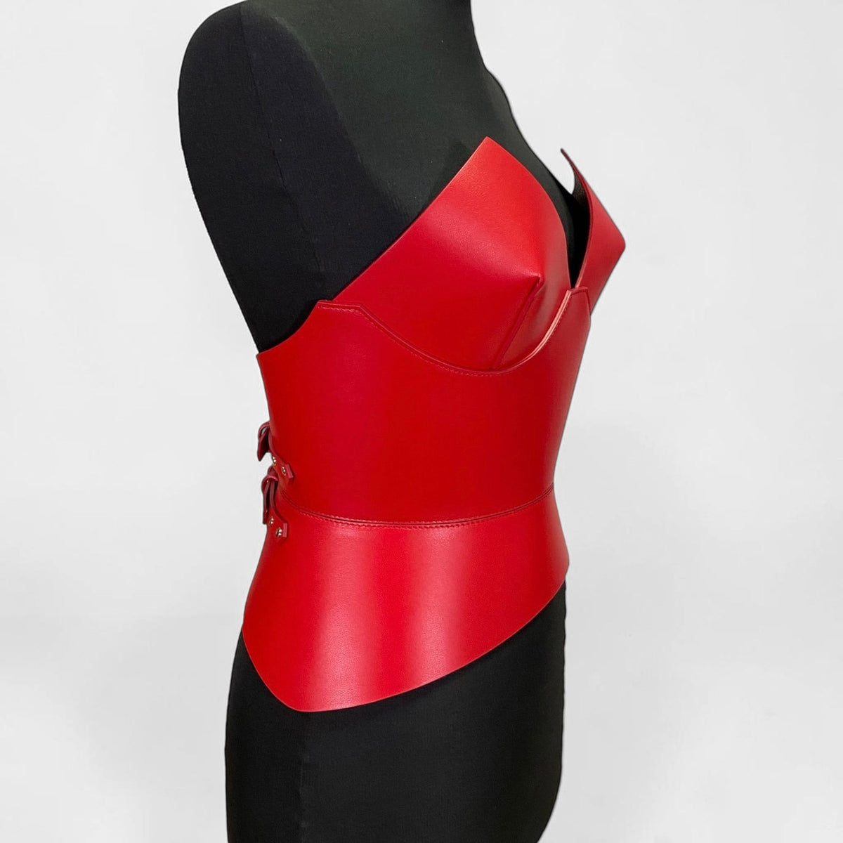 Aria Margo red Italian leather corset belt with a structured round body design on a black mannequin