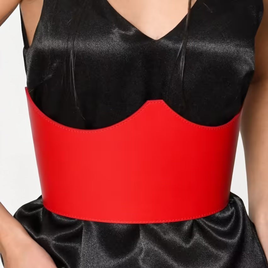 Aria Margo red Italian leather under-bust belt with a sculpted crown design worn over a black satin dress.