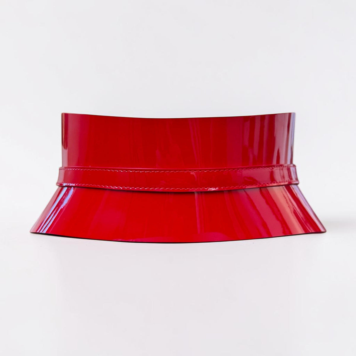 Aria Margo slim red patent leather corset belt with a high-shine finish and structured waist-defining design.