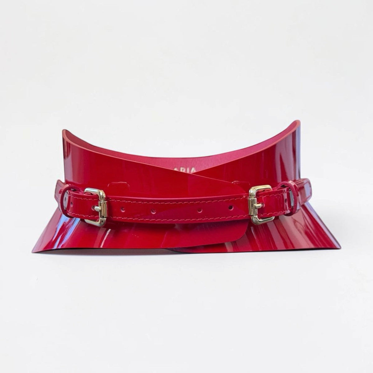 Aria Margo slim red patent leather corset belt with a high-shine finish and gold-tone buckle details.