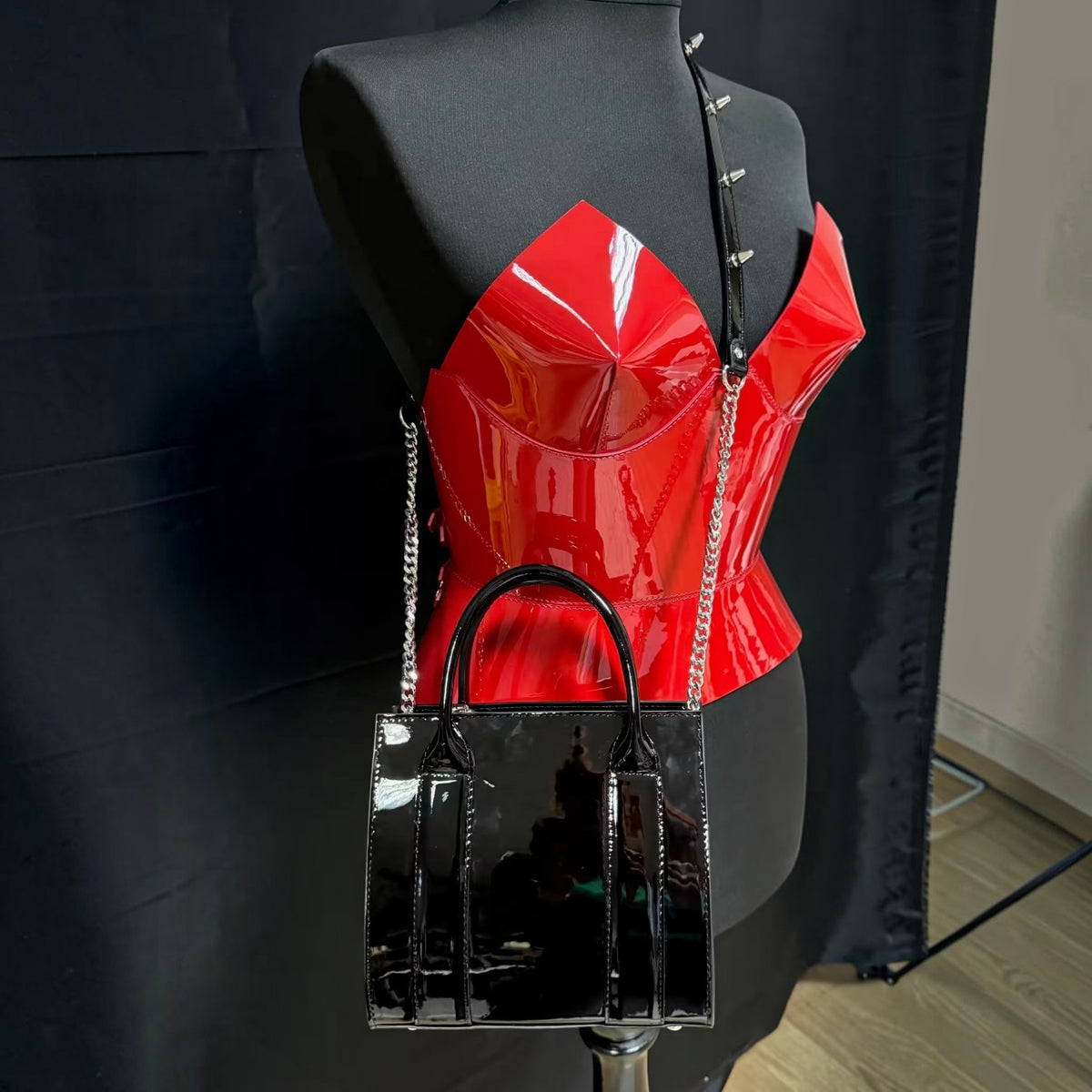 Aria Margo red patent leather corset with a structured bust and high-shine finish on a black mannequin