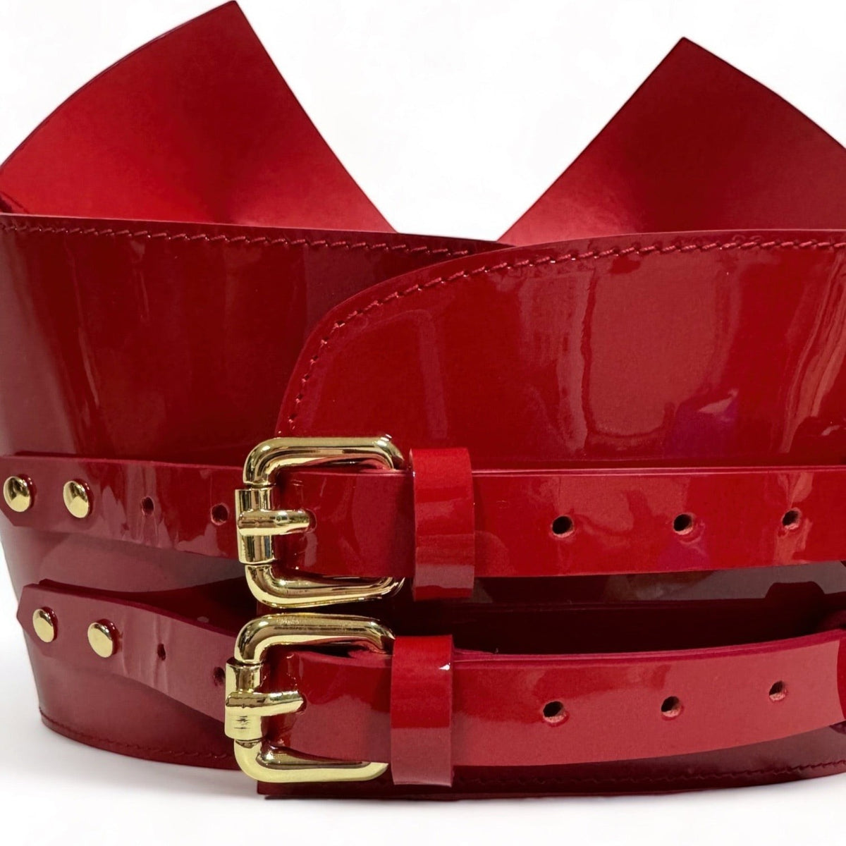 Aria Margo red patent leather corset with high-shine finish and gold buckle details on a white background.