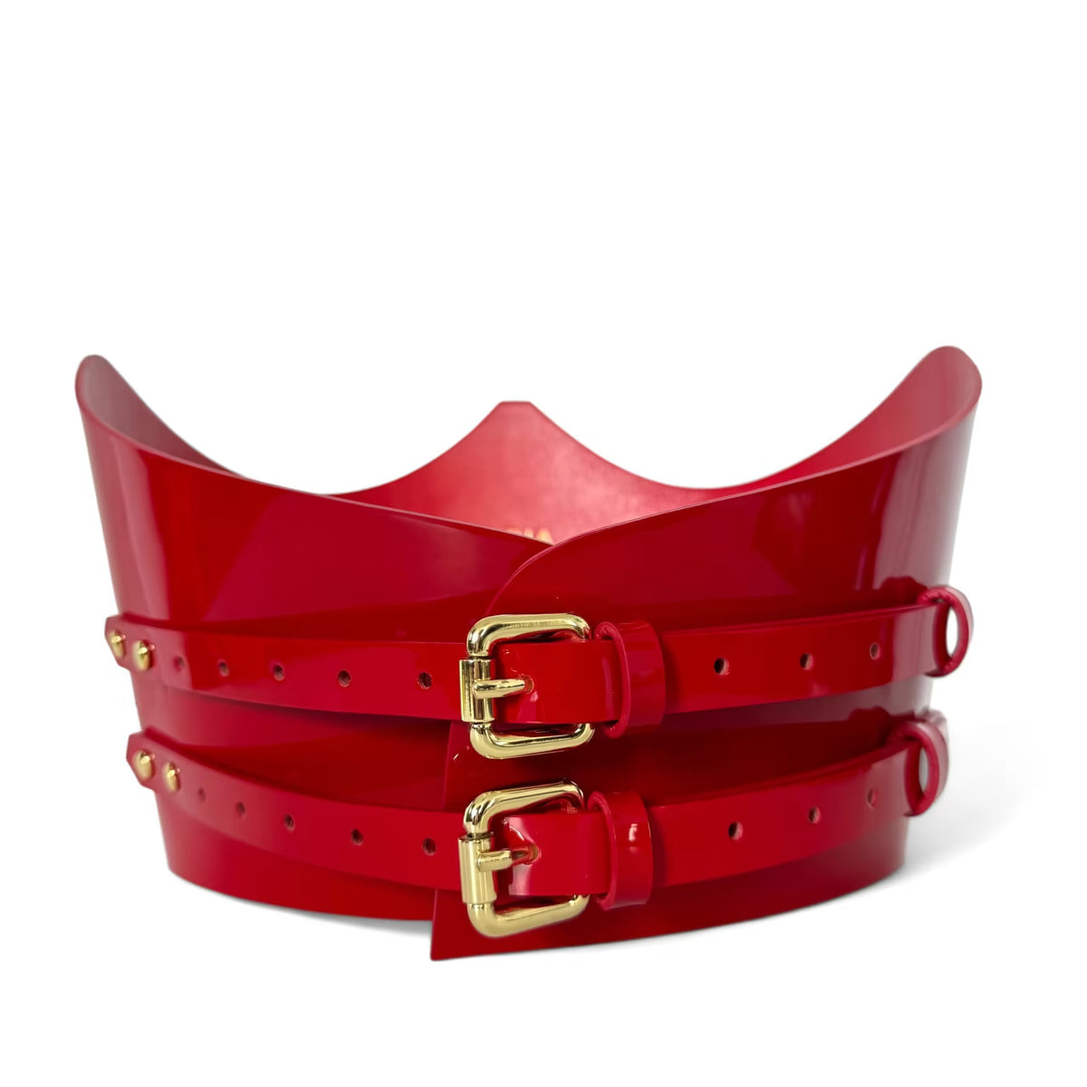 Aria Margo red patent leather under-bust belt with two gold-tone buckles and a sculpted crown-shaped top edge.