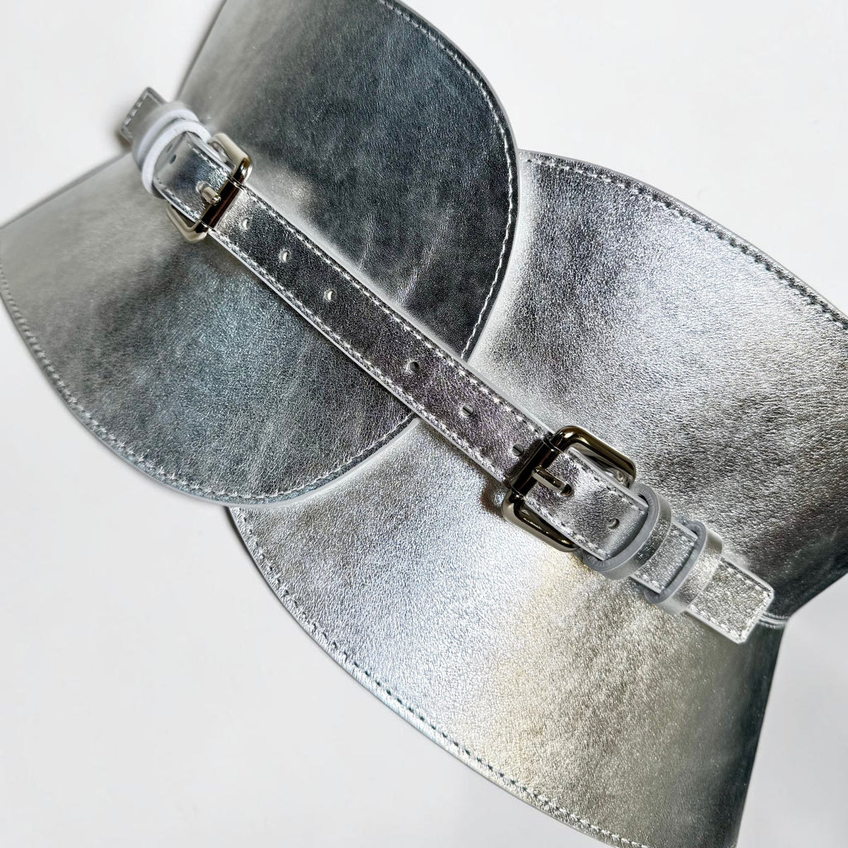 Aria Margo wide silver metallic leather corset belt with adjustable buckles and an hourglass silhouette.