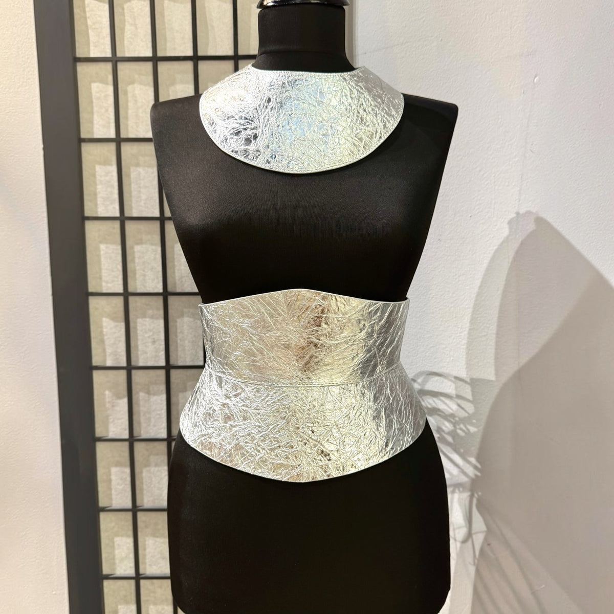 Aria Margo silver metallic Italian leather corset belt with an hourglass silhouette on a black mannequin.