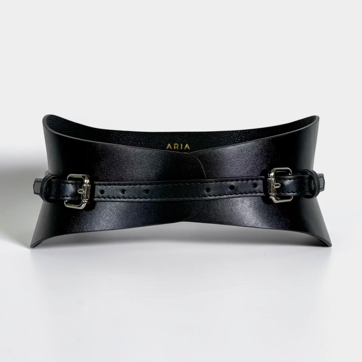 Aria Margo slim black Italian leather corset belt with dual buckle closures and a structured waist-cinching design.