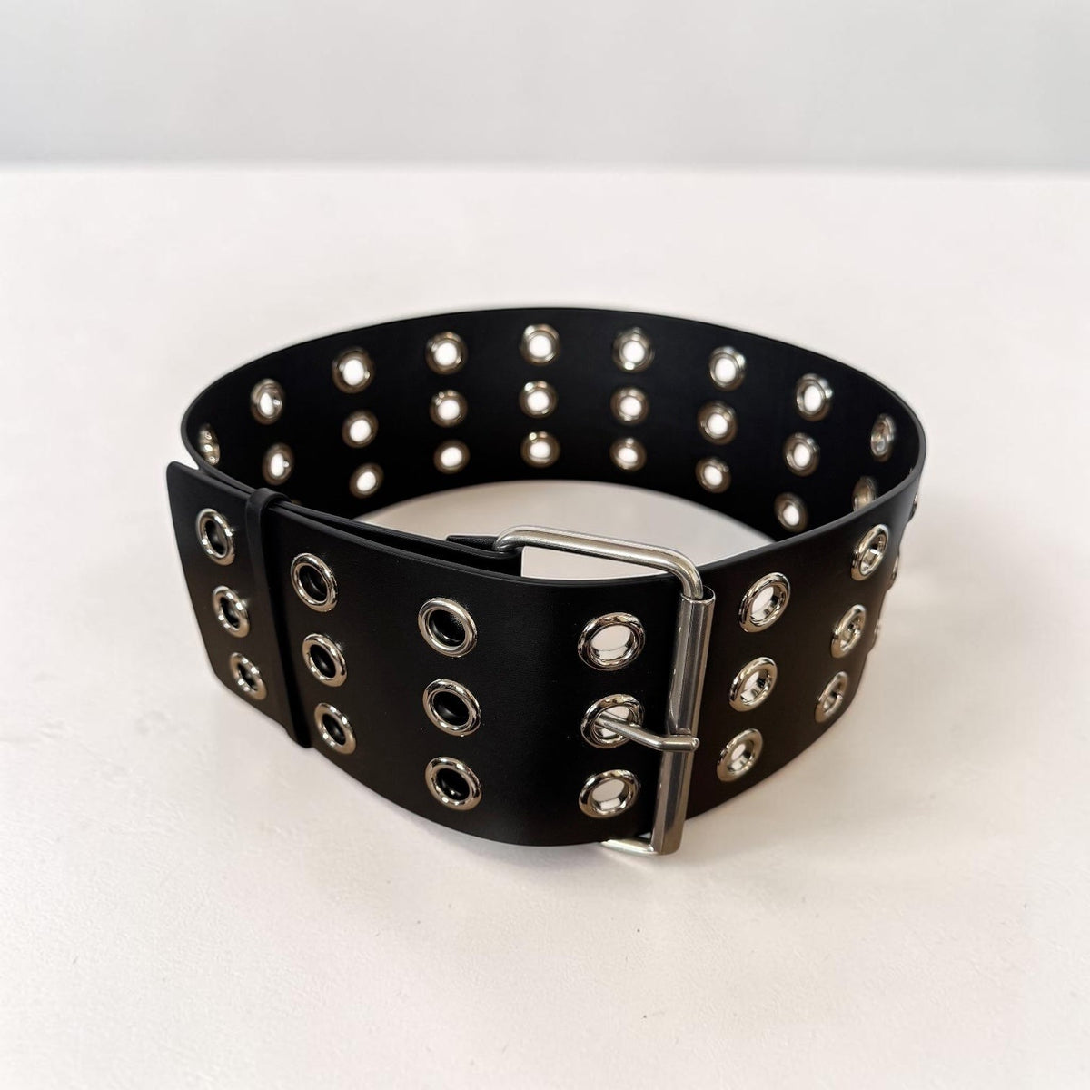 Aria Margo Test black Italian leather coat belt featuring silver-tone eyelets and a double-prong buckle.