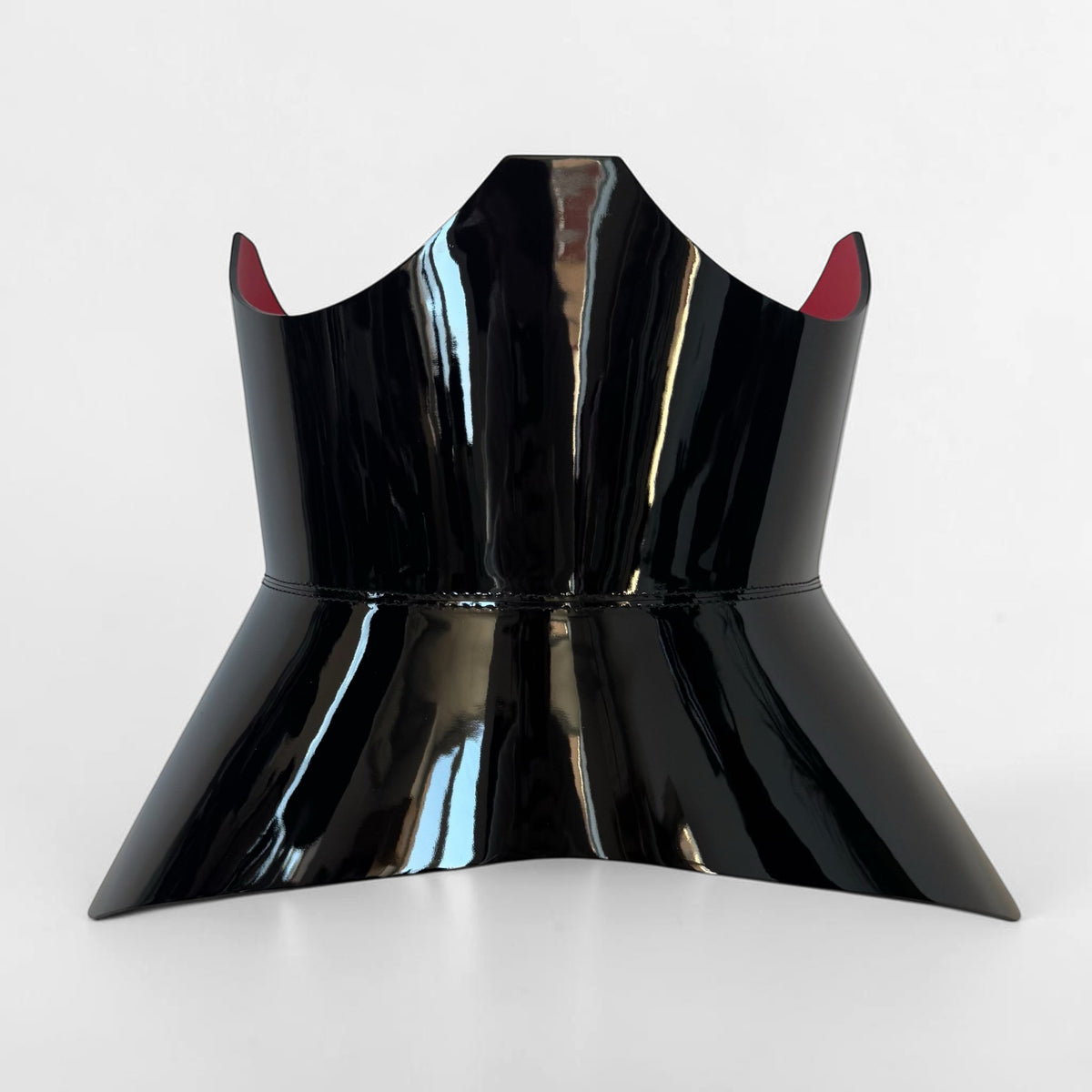 Aria Margo Test black patent leather corset belt with a high-shine finish and a contrasting red interior lining.