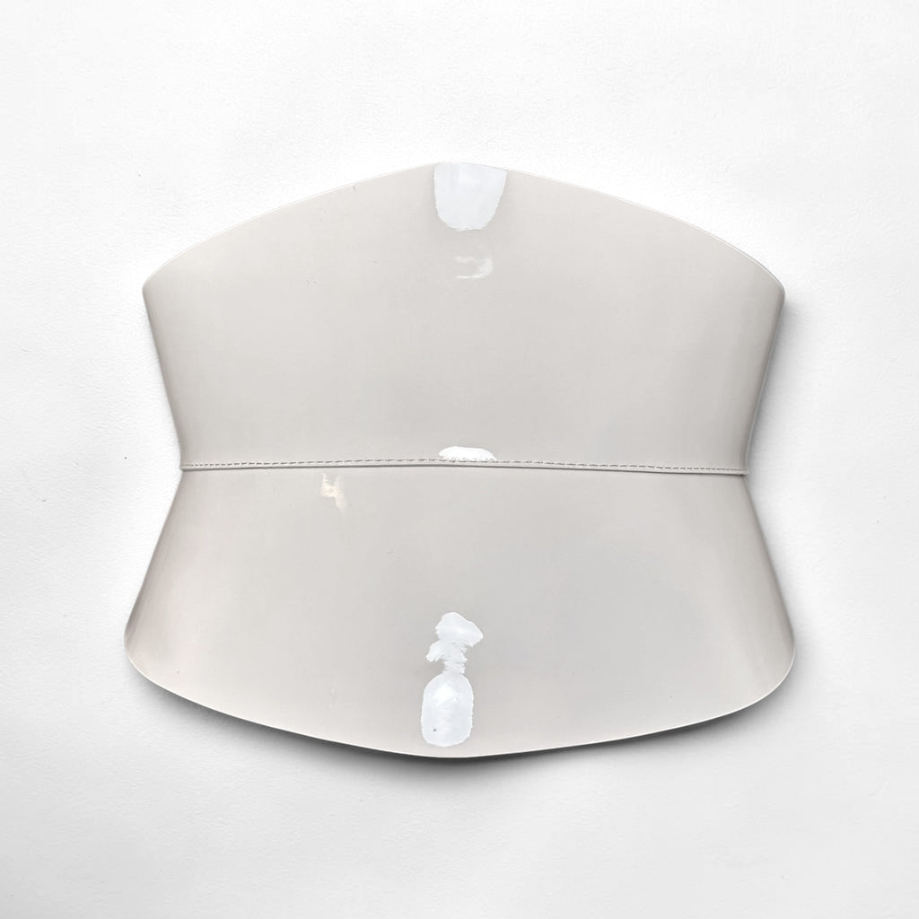 Aria Margo Test ivory patent leather corset belt with an hourglass silhouette and high-shine finish.
